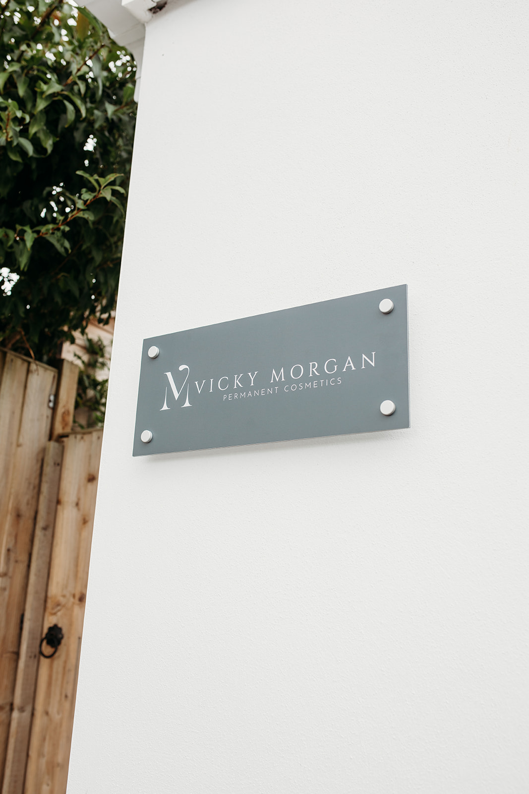 The Vicky Morgan Permanent Cosmetics sign beside the clinic door